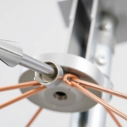 A close-up view of a lightning deflector system, showcasing its intricate components. The foreground features the primary conductor, a metal rod with a sharp tip, designed to capture and redirect electrical surges. The middle ground displays the grounding system, a series of sturdy copper wires connecting the conductor to the earth below. In the background, the protective housing, a sleek and weatherproof casing, adds an elegant touch to the overall design. The lighting is crisp and even, highlighting the metallic textures and the precision engineering of this essential safeguard against the power of nature.