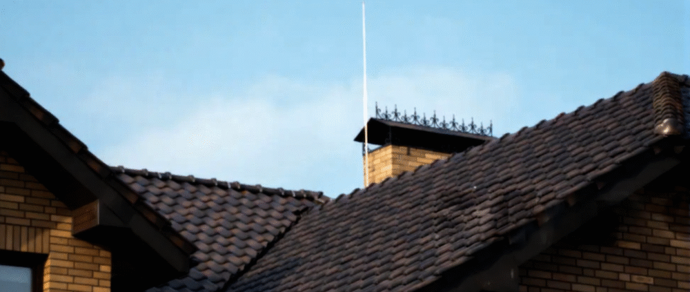 Lightning rod installed on residential house roof for protection.