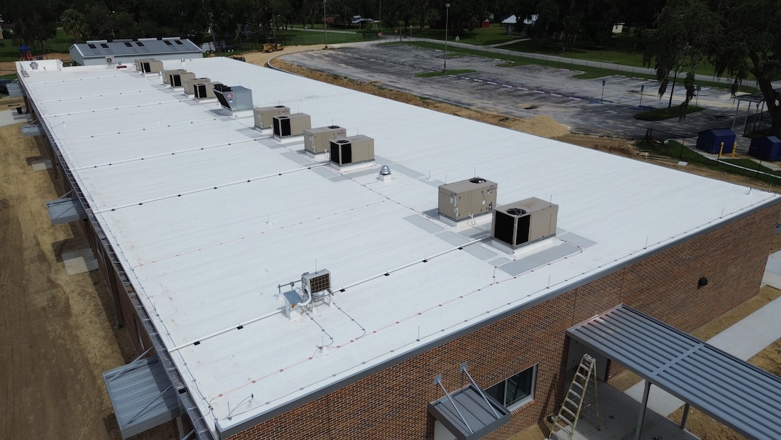 All South Lightning Protection technician installing NFPA 780 compliant system at Jacksonville FL educational facility 