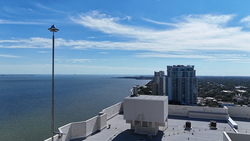Commercial lightning protection system installation on a Tampa Florida office building rooftop showing air terminals and conductor network