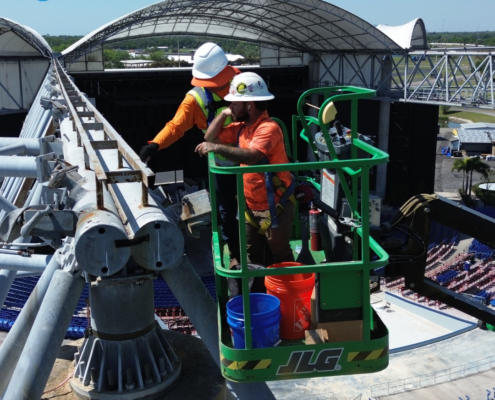 Lightning protection air terminal on commercial rooftop being inspected during lightning safety week