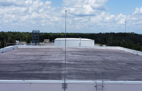 Lightning protection grounding electrode and bonding connection being tested during UL 96A recertification inspection at a Florida commercial facility