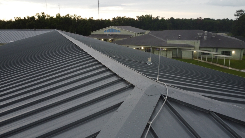 Lightning protection air terminals and conductors being inspected on a Florida commercial roof after membrane replacement for UL 96A recertification