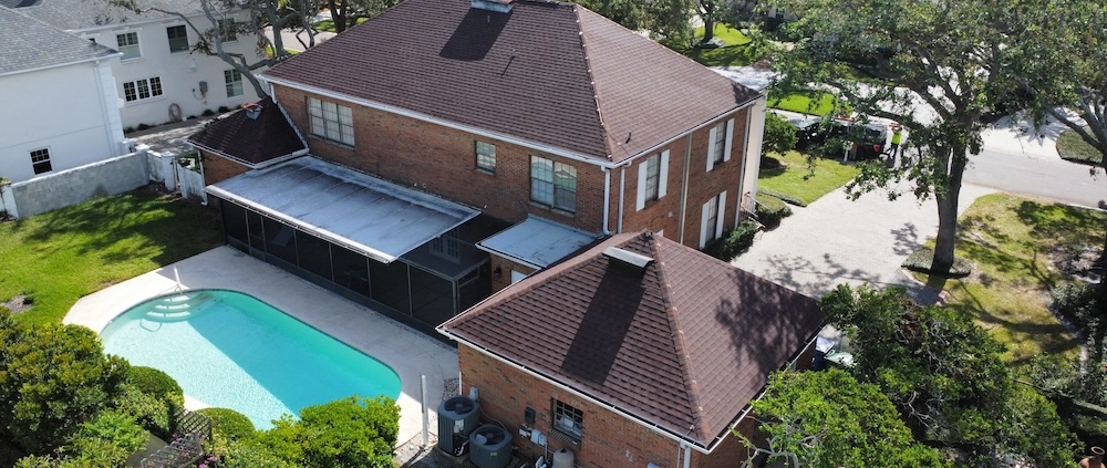 Residential lightning protection system with air terminals and down conductors installed on a Tampa home